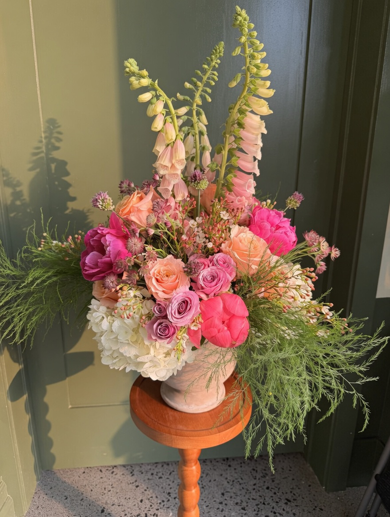 Lush, colorful floral display with a whimsical wildflower aesthetic.